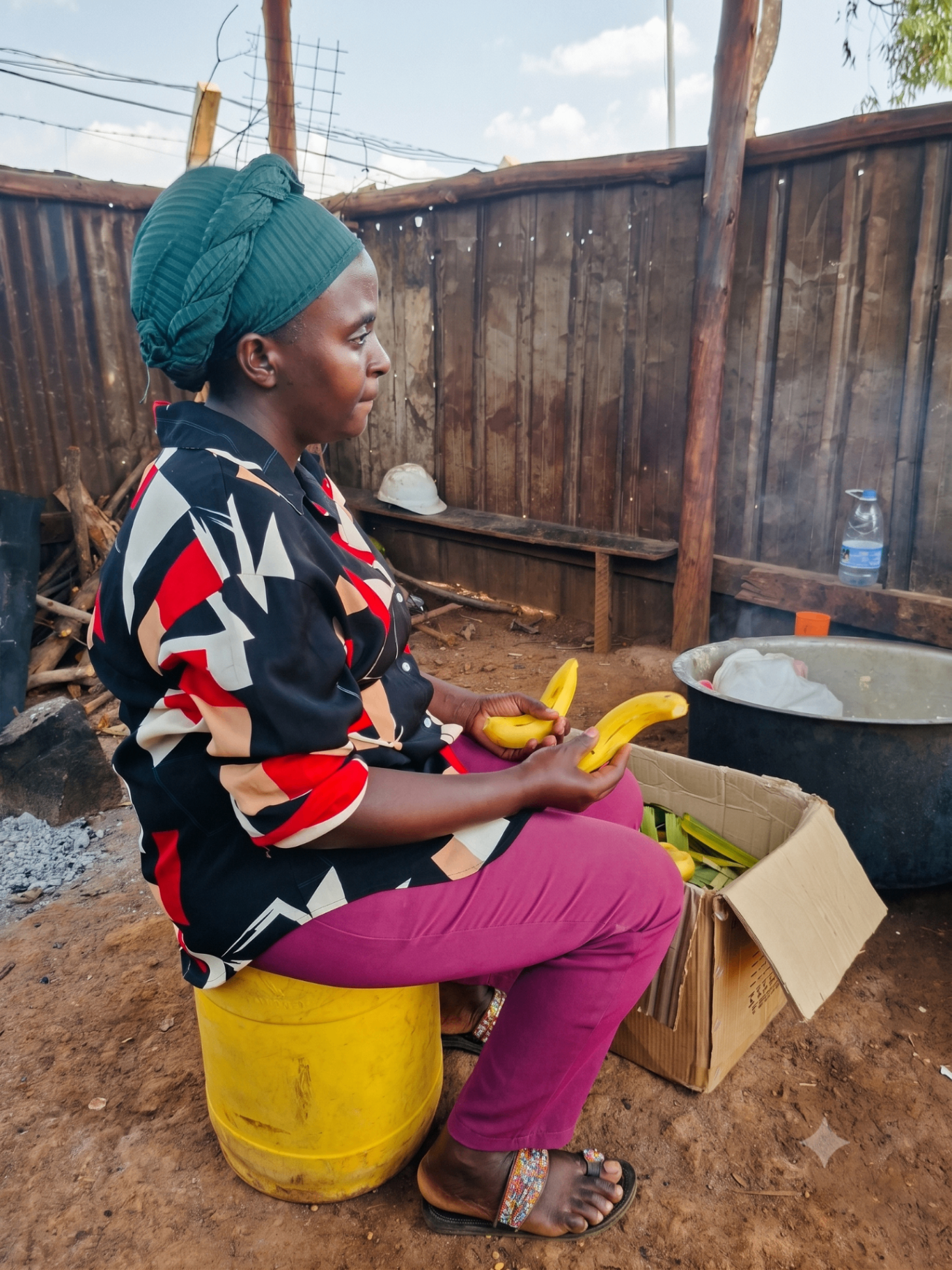 A Burlcore team member preparing fresh bananas on site in Busia